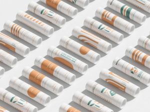 Custom printed tubes with vibrant colors and detailed designs, with a flowchart illustrating the collate printing process used in packaging.
