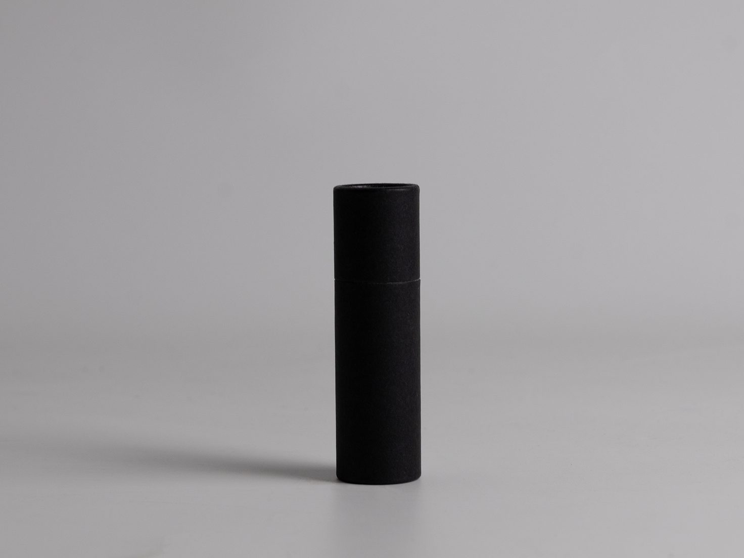 Cardboard push tube with bottom push-up mechanism, ideal for packaging natural lip balms, sunscreens, solid cosmetics, and skincare products.